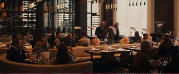 Movie still from “The Girlfriend Experience” (2009), directed by Steven Soderbergh – A group of people sitting around a restaurant eating and drinking; Wide shot, Over the shoulder angle