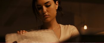 Movie still from “The Girlfriend Experience” (2009), directed by Steven Soderbergh – A beautiful young lady looking down at her face; Close Up shot, Low angle