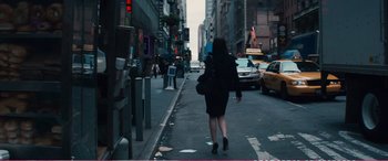 Movie still from “The Girlfriend Experience” (2009), directed by Steven Soderbergh – A woman walking down the street in a black dress; Wide shot, Over the shoulder angle