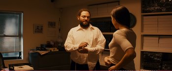 Movie still from “The Girlfriend Experience” (2009), directed by Steven Soderbergh – A man and a woman are talking in a kitchen; Medium shot, Over the shoulder angle