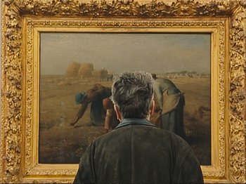 Movie still from “The Gleaners & I” (2000), directed by Agnès Varda – An older man looking at a painting of a field; Medium shot, Over the shoulder angle