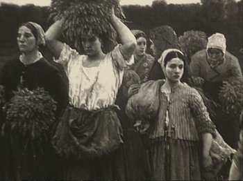 Movie still from “The Gleaners & I” (2000), directed by Agnès Varda – A black and white photo of a group of people; Medium shot, Low angle