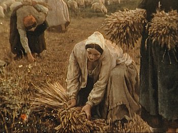 Movie still from “The Gleaners & I” (2000), directed by Agnès Varda – An old picture of a woman working in a field; Wide shot, High angle