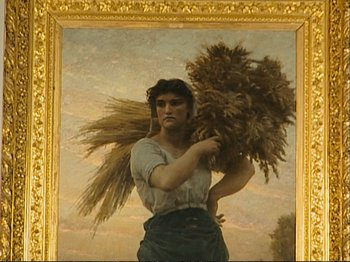 Movie still from “The Gleaners & I” (2000), directed by Agnès Varda – A painting of a woman holding a bundle of hay; Medium shot, Low angle