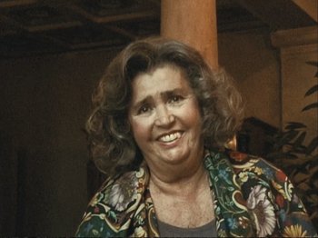 Movie still from “The Gleaners & I” (2000), directed by Agnès Varda – An older woman smiling for the camera; Close Up shot, High angle