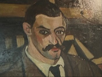 Movie still from “The Gleaners & I” (2000), directed by Agnès Varda – A painting of a man wearing a suit and a tie; Extreme Close Up shot, Overhead angle