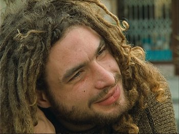 Movie still from “The Gleaners & I” (2000), directed by Agnès Varda – A person with dreads; Close Up shot, High angle