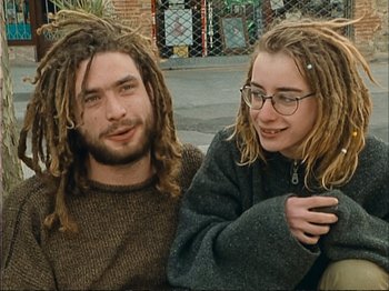 Movie still from “The Gleaners & I” (2000), directed by Agnès Varda – A man and a woman sitting next to each other with dreads; Close Up shot, High angle