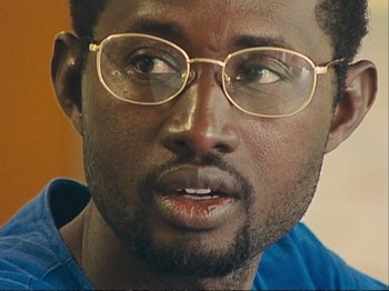 Movie still from “The Gleaners & I” (2000), directed by Agnès Varda – A person wearing glasses; Close Up shot, Over the shoulder angle