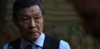 Movie still from “Altered Carbon” (2018), created by Laeta Kalogridis – An older man wearing a tie and a white dress shirt; Close Up shot, Low angle
