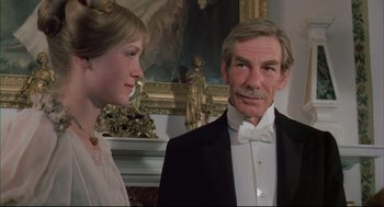 Movie still from “The Go-Between” (1971), directed by Joseph Losey – An older man in a tuxedo and a young woman in a white dress; Close Up shot, Low angle