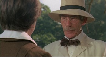 Movie still from “The Go-Between” (1971), directed by Joseph Losey – An older man wearing a hat and a bow tie talking to a woman; Close Up shot, Low angle