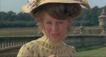 Movie still from “The Go-Between” (1971), directed by Joseph Losey – A person wearing a dress and a hat; Close Up shot, Over the shoulder angle