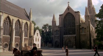 Movie still from “The Go-Between” (1971), directed by Joseph Losey – An old fashioned carriage in front of an old church; Extreme Wide shot, High angle