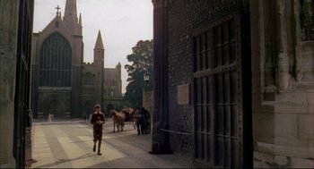 Movie still from “The Go-Between” (1971), directed by Joseph Losey – A man walking down a street with a horse and carriage; Extreme Wide shot, High angle