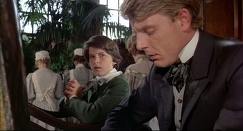 Movie still from “The Go-Between” (1971), directed by Joseph Losey – A man and a woman are praying in a church; Medium shot, Over the shoulder angle