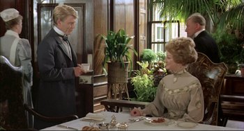 Movie still from “The Go-Between” (1971), directed by Joseph Losey – A man and a woman sitting at a dining table; Medium shot, Over the shoulder angle