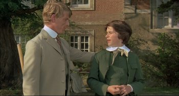 Movie still from “The Go-Between” (1971), directed by Joseph Losey – A man and a woman standing next to each other; Medium shot, Over the shoulder angle