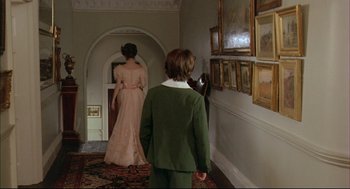 Movie still from “The Go-Between” (1971), directed by Joseph Losey – A woman and a boy in a dress in a room; Wide shot, Over the shoulder angle