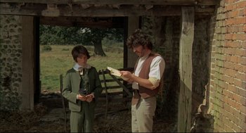 Movie still from “The Go-Between” (1971), directed by Joseph Losey – A man and a woman standing next to each other in front of a tree; Medium shot, Over the shoulder angle