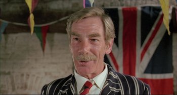 Movie still from “The Go-Between” (1971), directed by Joseph Losey – An older man wearing a suit and tie; Close Up shot, Low angle