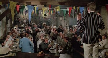 Movie still from “The Go-Between” (1971), directed by Joseph Losey – A group of people sitting around a table; Wide shot, High angle