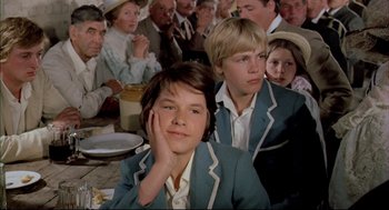 Movie still from “The Go-Between” (1971), directed by Joseph Losey – A group of people sitting around a table; Close Up shot, High angle