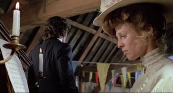 Movie still from “The Go-Between” (1971), directed by Joseph Losey – A woman in a hat and a man in a suit and tie; Medium shot, Over the shoulder angle