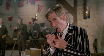 Movie still from “The Go-Between” (1971), directed by Joseph Losey – An older man wearing a striped suit and a tie; Close Up shot, Low angle