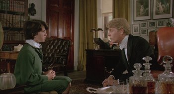 Movie still from “The Go-Between” (1971), directed by Joseph Losey – A man and a woman sitting at a table talking to each other; Medium shot, Over the shoulder angle