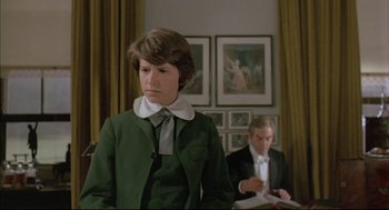 Movie still from “The Go-Between” (1971), directed by Joseph Losey – A woman in a green jacket and a man in a white tie; Medium shot, Over the shoulder angle