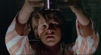 Movie still from “The Go-Between” (1971), directed by Joseph Losey – A young boy is holding a cell phone up to his face; Close Up shot, Low angle