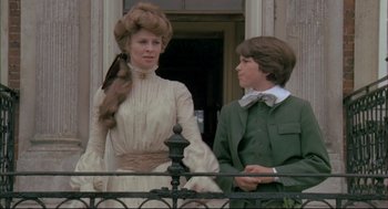 Movie still from “The Go-Between” (1971), directed by Joseph Losey – A woman and a young boy standing next to each other; Medium shot, Low angle