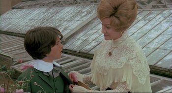 Movie still from “The Go-Between” (1971), directed by Joseph Losey – A woman in a white dress and a man in a green jacket; Medium shot, Over the shoulder angle