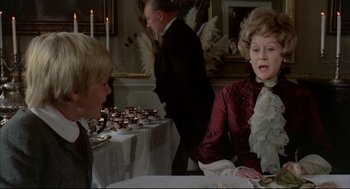 Movie still from “The Go-Between” (1971), directed by Joseph Losey – Two people are sitting at a table with food on it; Medium shot, Over the shoulder angle