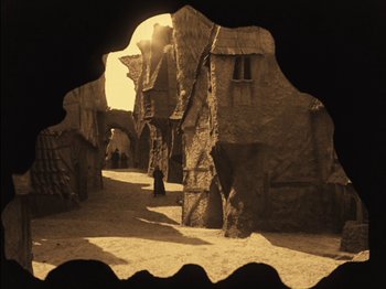 Movie still from “The Golem” (1920), directed by Paul Wegener – An old photograph of an old town in the middle of the day; Wide shot, High angle