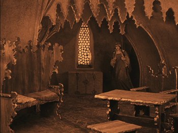 Movie still from “The Golem” (1920), directed by Paul Wegener – A room that has a statue in it; Wide shot, High angle