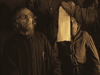 Movie still from “The Golem” (1920), directed by Paul Wegener – A man and a woman standing next to each other; Medium shot, Low angle