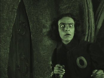 Movie still from “The Golem” (1920), directed by Paul Wegener – A man with a surprised look on his face; Medium shot, Low angle