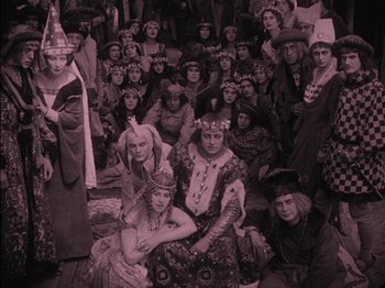 Movie still from “The Golem” (1920), directed by Paul Wegener – A group of people dressed up in costumes for halloween; Wide shot, High angle