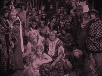 Movie still from “The Golem” (1920), directed by Paul Wegener – A group of people dressed up in costumes; Wide shot, High angle