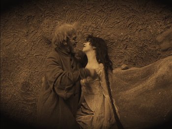Movie still from “The Golem” (1920), directed by Paul Wegener – A man and a woman are standing next to each other; Wide shot, High angle