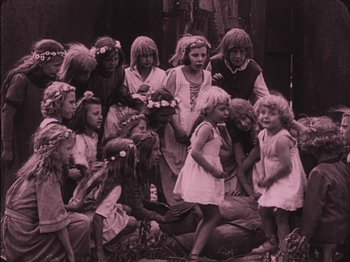 Movie still from “The Golem” (1920), directed by Paul Wegener – A group of young children posing for a picture; Wide shot, High angle