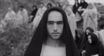 Movie still from “The Gospel According to St. Matthew” (1964), directed by Pier Paolo Pasolini – Black and white photograph of a man with a beard; Close Up shot, Low angle
