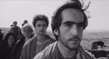 Movie still from “The Gospel According to St. Matthew” (1964), directed by Pier Paolo Pasolini – A group of men standing next to each other; Close Up shot, Low angle