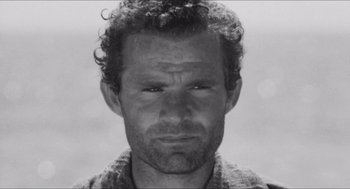 Movie still from “The Gospel According to St. Matthew” (1964), directed by Pier Paolo Pasolini – Black and white photograph of a man's face; Close Up shot, Low angle