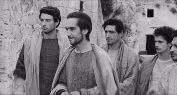 Movie still from “The Gospel According to St. Matthew” (1964), directed by Pier Paolo Pasolini – A group of men standing next to each other; Medium shot, Over the shoulder angle