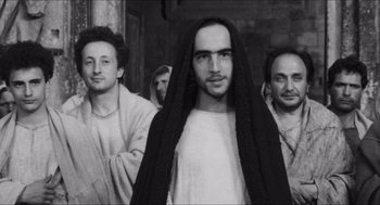 Movie still from “The Gospel According to St. Matthew” (1964), directed by Pier Paolo Pasolini – A group of men standing next to each other; Close Up shot, Low angle