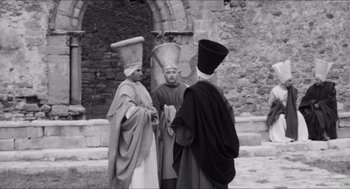 Movie still from “The Gospel According to St. Matthew” (1964), directed by Pier Paolo Pasolini – A group of men standing next to each other; Wide shot, Over the shoulder angle