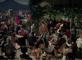 Movie still from “The Great Caruso” (1951), directed by Richard Thorpe – A group of people sitting at tables in an outdoor restaurant; Extreme Wide shot, High angle